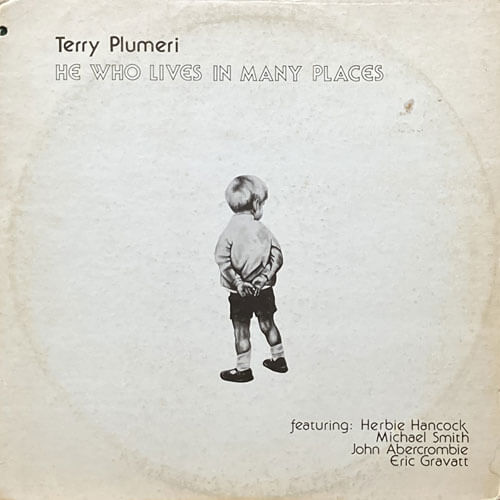TERRY PLUMERI / HE WHO LIVES IN MANY PLACES